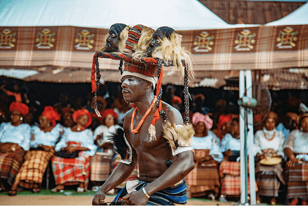 Ceremonial dancer in elaborate headdress at Arochukwu New Yam Festival