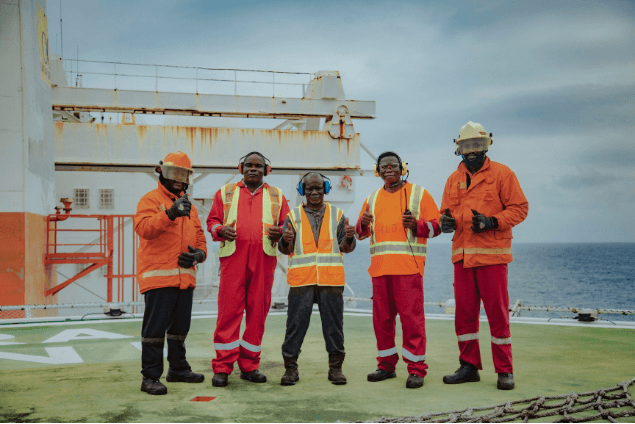 Five offshore workers in PPE on the helideck