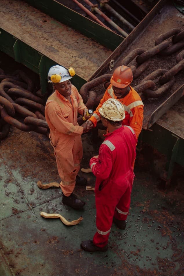 Workers shaking hands on the industrial deck