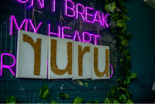 Ruru letter canvases against the neon Don't Break My Heart sign