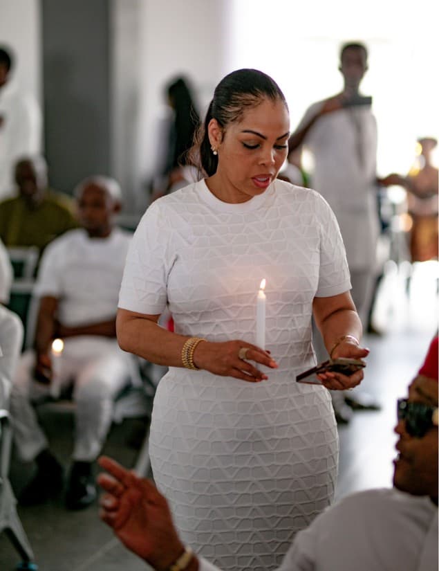 Attendee holding a lit candle in remembrance